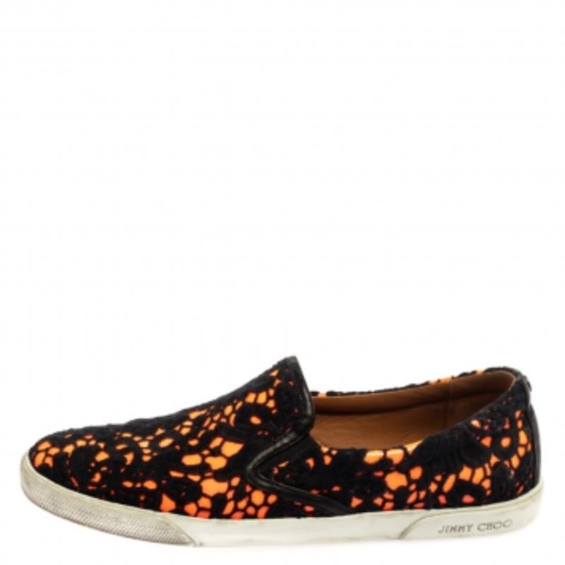 One's wardrobe is incomplete without a good pair of sneakers and what better than these Jimmy Choo ones! These black & neon orange slip-on sneakers have been crafted from lace and patent leather. They are styled with round toes and durable rubber
