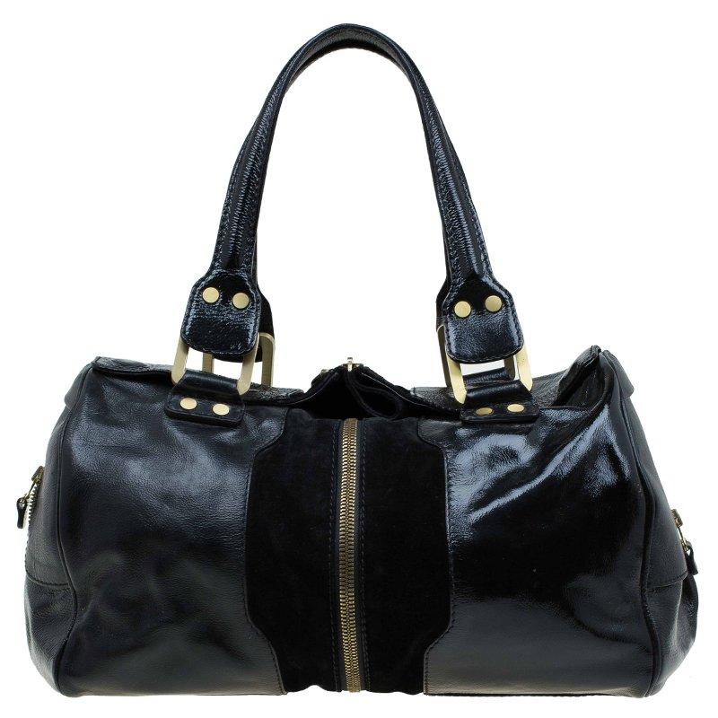 This patent leather and suede bag features an external middle zipper that expands the bag- the ultimate in functionality while still remaining sophisticated, reflective of Jimmy Choo style. Wide flat top handles with 25cm drop, side zip pockets, and