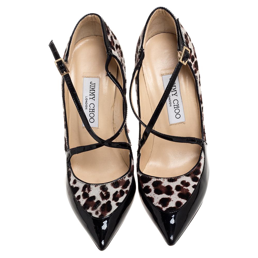 Stand out and strut in style with these Jimmy Choo pumps. Crafted from patent leather and pony hair, they feature crisscross straps on the vamps, pointed toes, buckle fastenings, and towering stiletto heels. Lined with leather, they are designed as