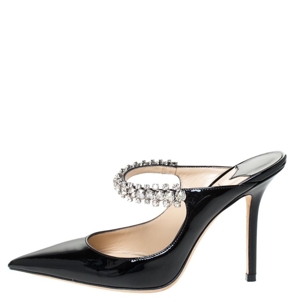 Designed to impart a resolutely feminine appeal, Jimmy Choo's Bing shoe is for fashionable expeditions. The mule features a patent leather pointed toe and a single strap adorned with crystals. The delicate shoe is elevated by a slim heel.

