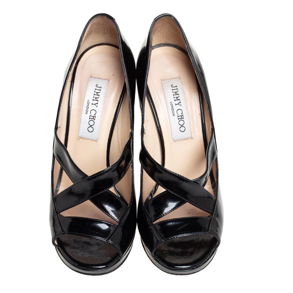 Featuring cross straps at the front, open toes, low platforms, and 11.5 cm high heels, Jimmy Choo's Gesture pumps offer elegant appeal and comfortable elevation. They're crafted in patent leather and detailed with the brand label on the