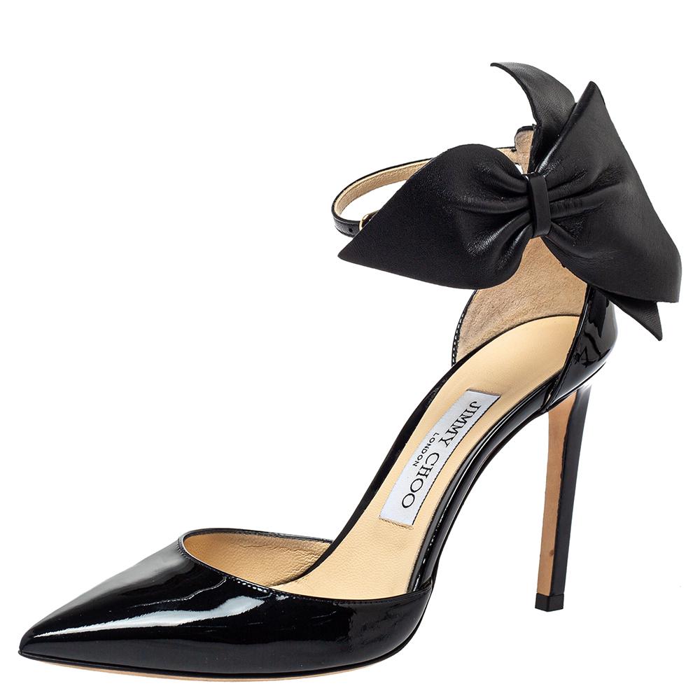 Add a feminine touch to your outfit with this pair of Jimmy Choo pumps. Look refined and sophisticated by flaunting this pair of patent leather pumps. They come designed with bow-detailed counters, pointed toes, and high stiletto heels.

Includes:
