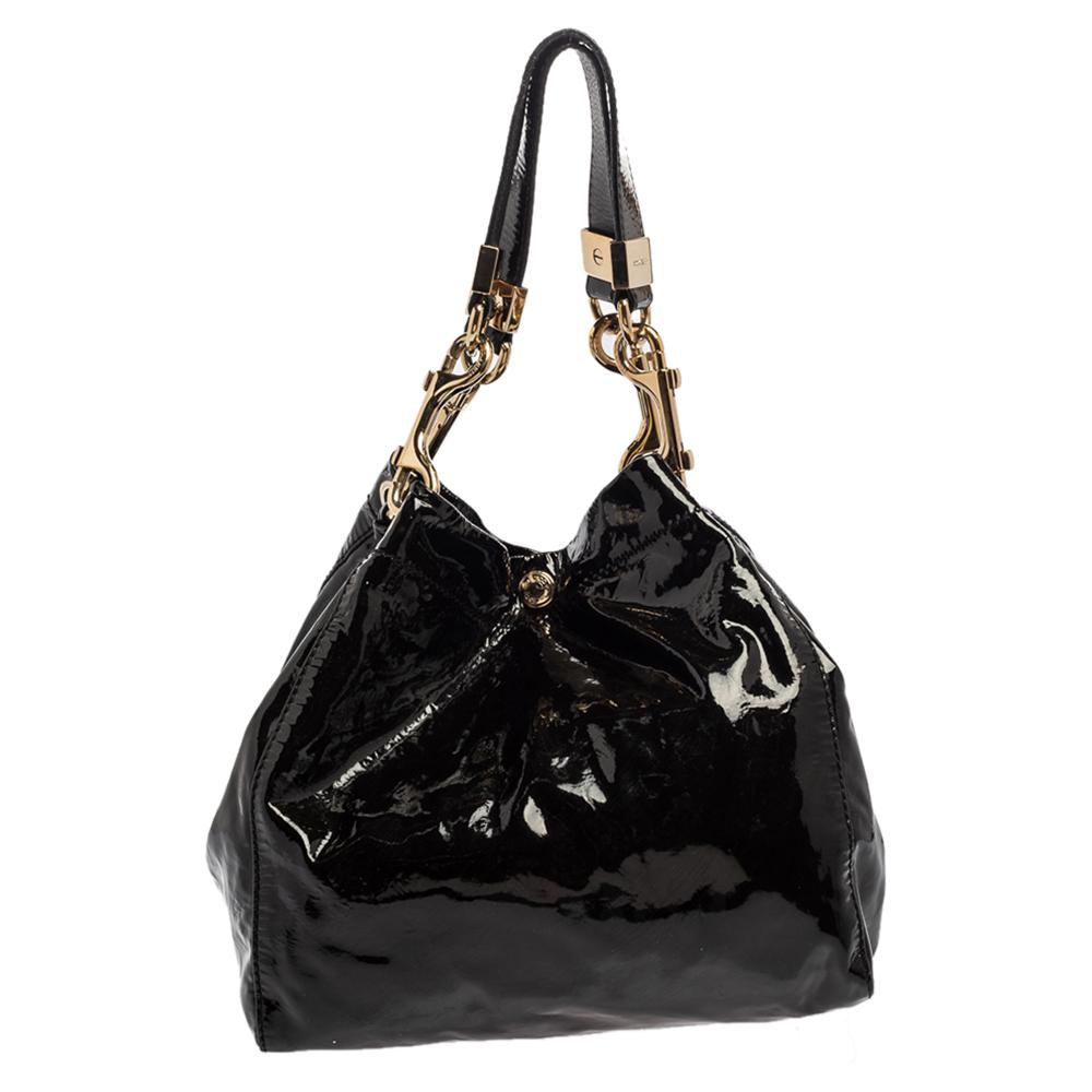 Crafted from patent leather, this black Jimmy Choo tote comes with a spacious suede-lined interior. The bag is equipped with two handles and gold-tone hardware. Swing this beauty wherever you go to lend your outfit the appropriate measure of class