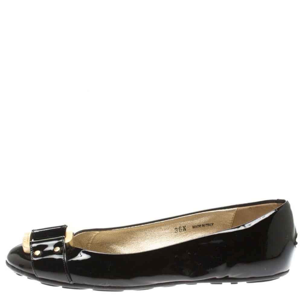Beautiful and sophisticated, these Morse ballet flats from Jimmy Choo are a perfect alternative to your party heels. Rendered in black patent leather, the pair is styled with round toes and metal buckle accents on the vamps that gives the pair its