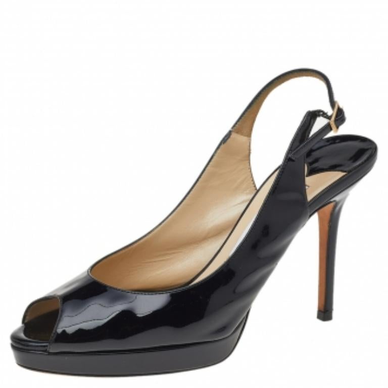 Jimmy Choo's timeless aesthetic and stellar craftsmanship in shoemaking is evident in these versatile sandals. Crafted from black patent leather, the peep-toe silhouette is adorned with sleek cuts and then raised on high heels supported by platforms.