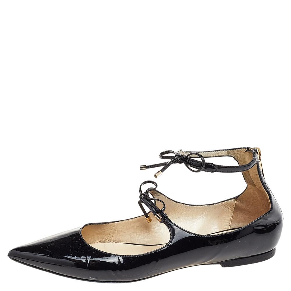 These elegant Jimmy Choo ballet flats will be your favorite go-to option for any special occasion. They have been crafted from patent leather and come covered in a black shade. They are styled with pointed toes, double bow-detailed ankle straps, and