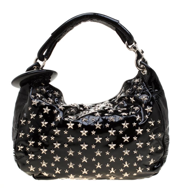 A bag for all reasons and seasons, this Jimmy Choo bag has a beautiful patent leather exterior covered in star studs and a suede interior to house your belongings. The hobo is easy to hold and flaunt.

Includes: Original Dustbag, Authenticity Card