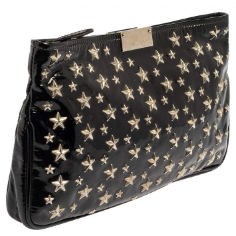 A stylish clutch is an everyday staple! This Zulu clutch from the house of Jimmy Choo is crafted from classic black-hued patent leather. The piece is equipped with a top zipper that reveals a well-sized canvas-lined compartment and it flaunts star