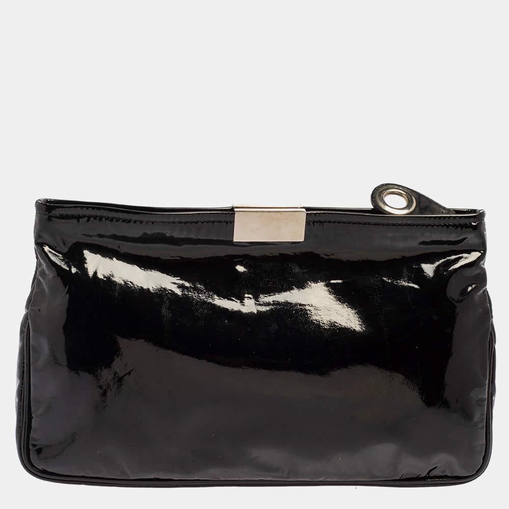  A stylish clutch is an everyday staple! This Zulu clutch from the house of Jimmy Choo is crafted from classic black-hued patent leather. The piece is equipped with a top zipper that reveals a well-sized canvas-lined compartment and it flaunts star
