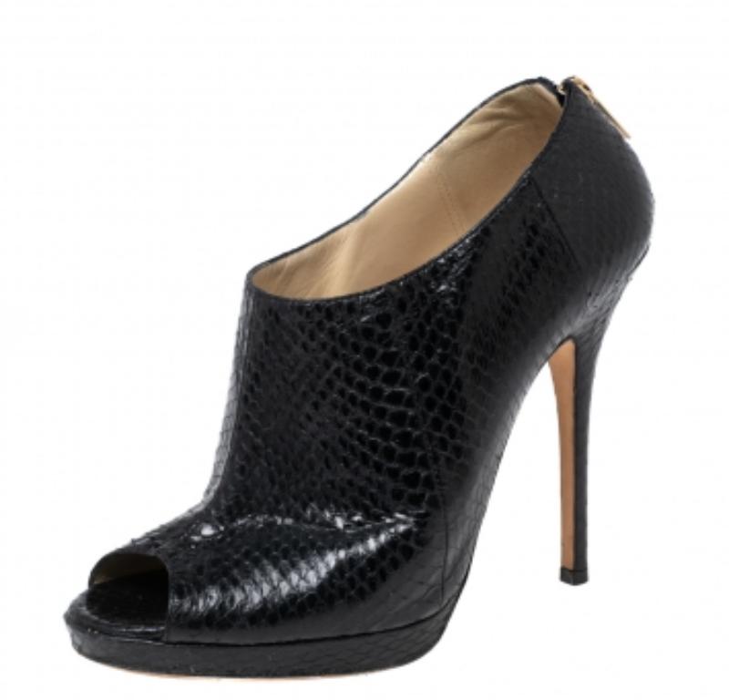 Work the look with Jimmy Choo’s black booties, which feature a peep toe and sturdy stiletto heel. Exquisitely crafted in black python leather and are finished with back zippers for secured fit. This pair will balance midi-length hemlines perfectly.