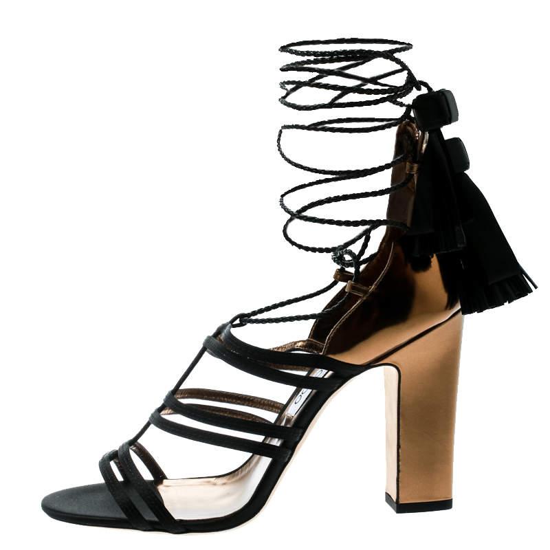 These sandals from Jimmy Choo are utterly gorgeous! The sandals are crafted from leather and satin and designed in a strappy layout bound by back zippers and tie-ups around the ankles. Balanced on block heels, this lovely pair will have everyone in