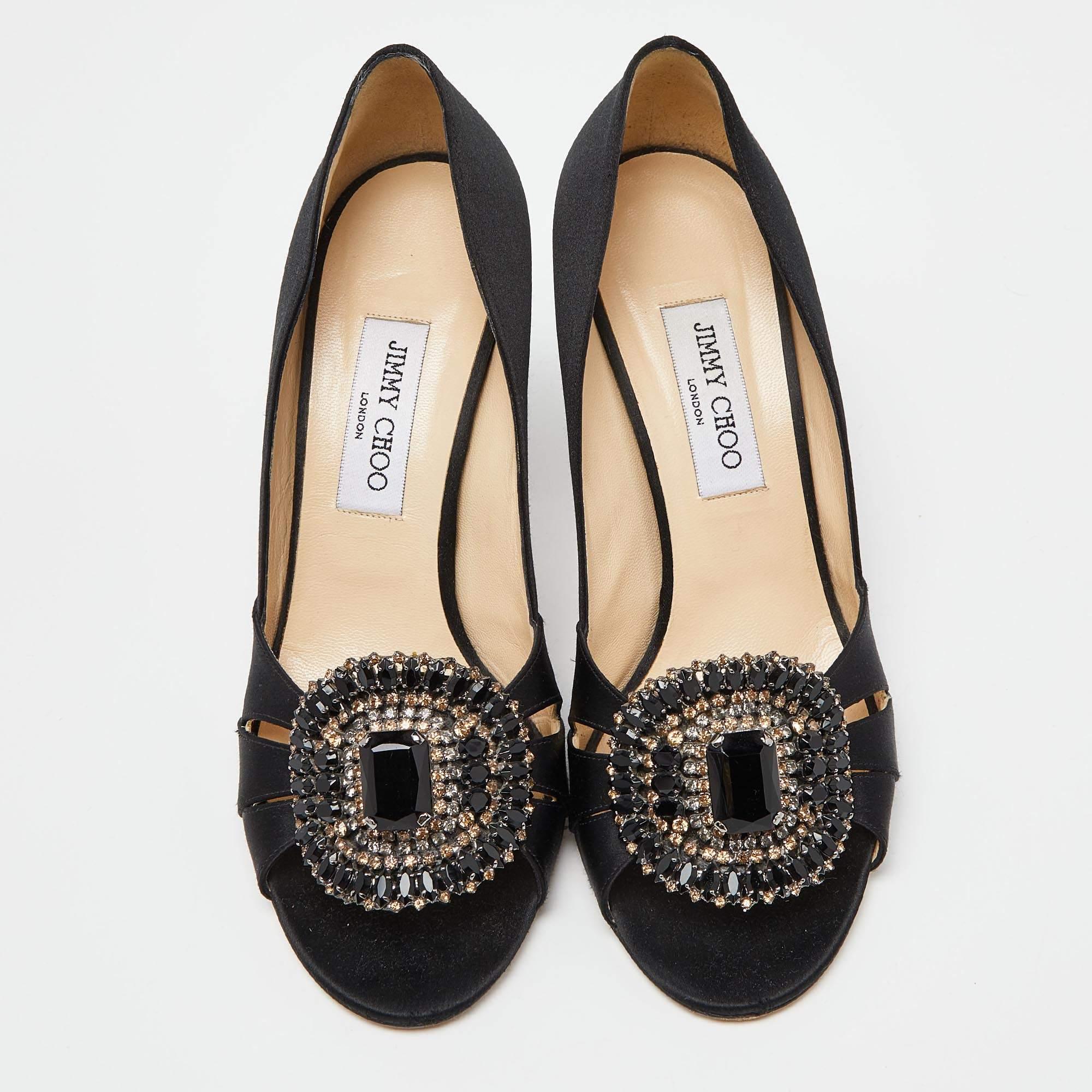 These chic and classic Jimmy Choo peep-toe pumps can be worn to evening parties as well as dinner outings. The pair is crafted with soft satin in a black hue. They come with embellishments and cutouts on the vamps, and 9.5cm high heels.


