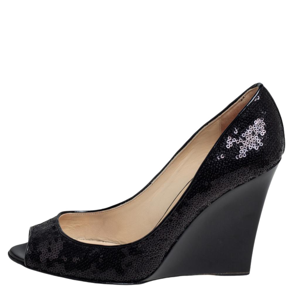 Add this exquisite pair of Jimmy Choo pumps to your closet for maximum style and comfort. Look refined and sophisticated by flaunting this pair of sequin-embellished pumps that are set on wedge heels. The pumps are complete with peep toes and sturdy