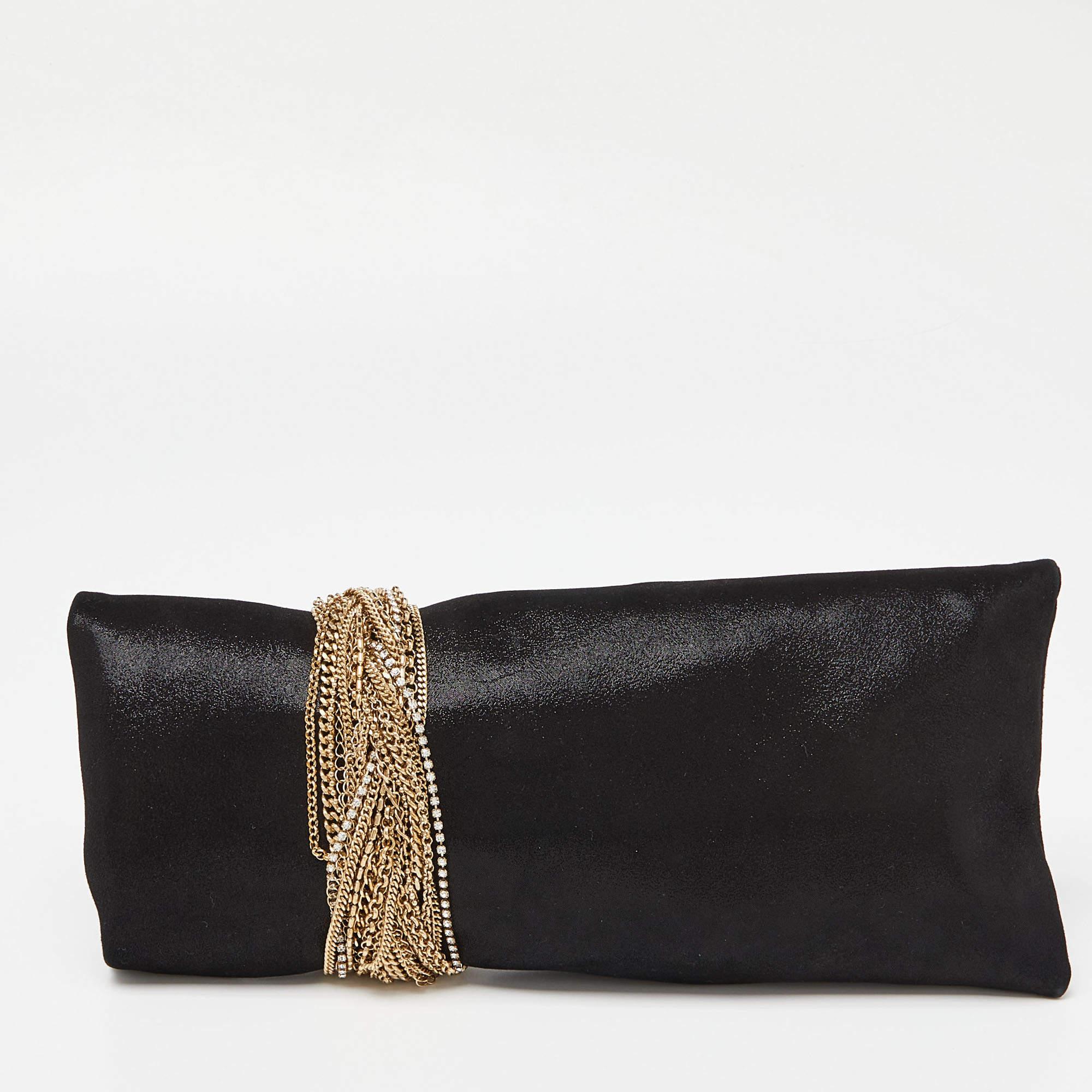 Sprinkle grace and style in every swing with this Chandra clutch from Jimmy Choo. Crafted from shimmering leather, the piece is styled with gold-tone chain details that are wound around the clutch, ending as the clasp. The insides are lined with