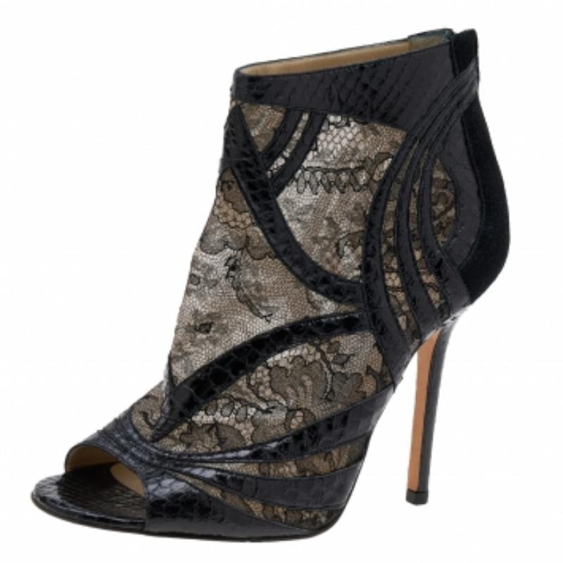 These stunning booties by Jimmy Choo are absolute must-haves. Crafted from black lace and snakeskin leather, these gorgeous boots make a bold statement. With an interesting play of textures, they showcase peep toes, gold-tone zip closures, and