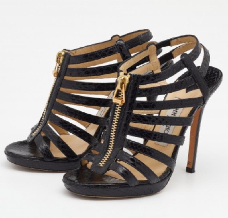 From the house of Jimmy Choo comes this pair of sandals that are simply splendid. They've been crafted from snakeskin leather and are styled in a gladiator design with front zippers. They are complete with 12 cm heels and comfortable leather insoles.