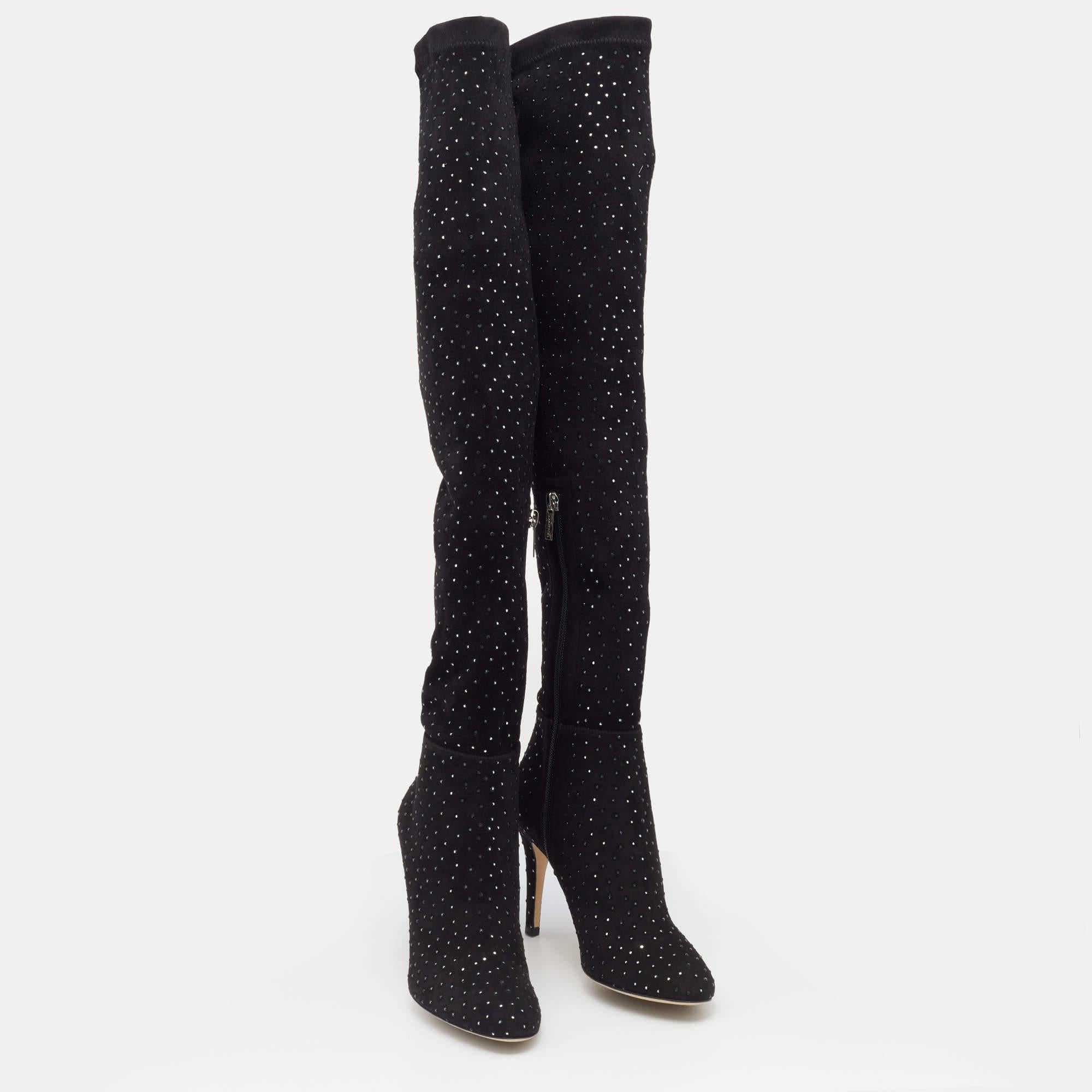 Jimmy Choo brings you this fabulous pair of thigh-high boots that will give you confidence and loads of style. The shoes have been crafted from stretch fabric in a classy black shade and styled with embellishments and 9 cm heels.

includes
Original