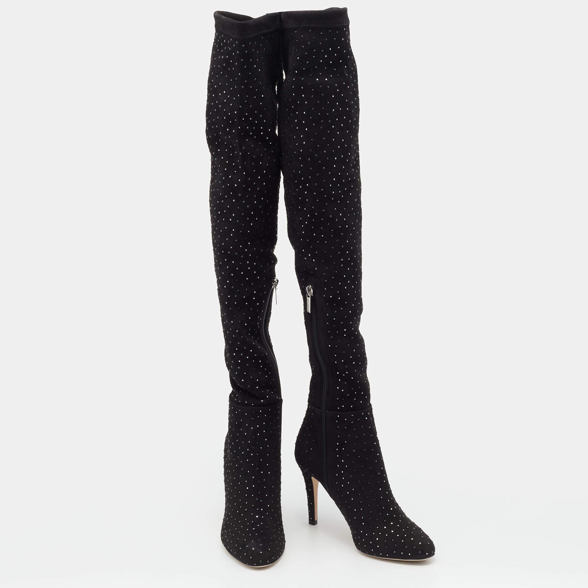 Jimmy Choo brings you this fabulous pair of thigh-high boots that will give you confidence and loads of style. The shoes have been crafted from stretch fabric in a classy black shade and styled with embellishments and 9 cm heels.


Includes
Original