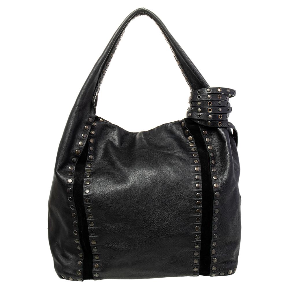 This leather bag is gorgeous enough to upgrade any look. The interior is artfully lined with fabric and leather, adding to the bag's high style quotient. Designed to last, this fabulous handbag from Jimmy Choo can elevate the look of your wardrobe.

