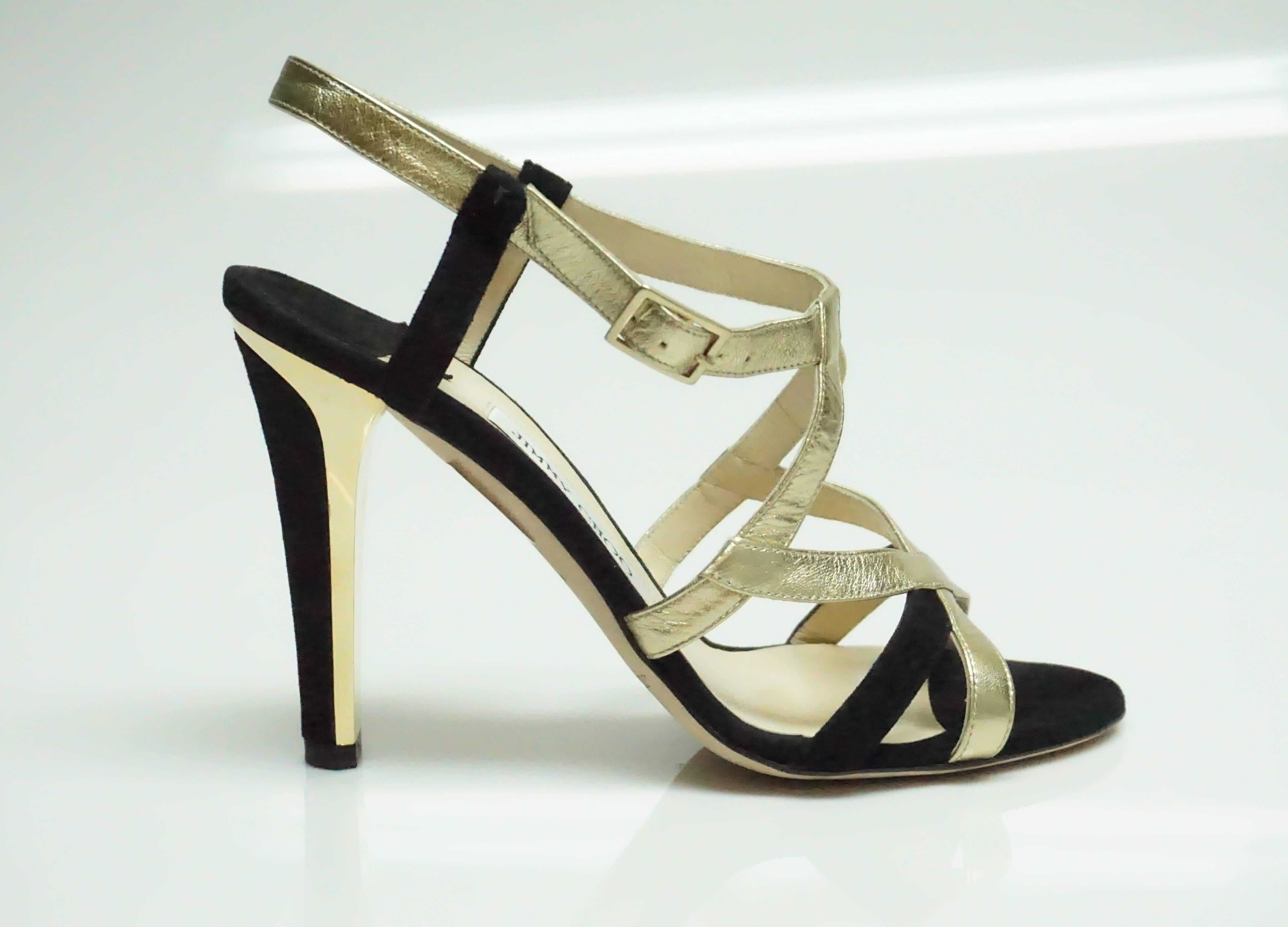 Jimmy Choo Black Suede and Gold Metallic Leather Strappy Heel - 39  These modern heels are in excellent condition and have a very sharp look to them. The Heel has a gold metal accent around the black suede. They have little to no wear on the inside