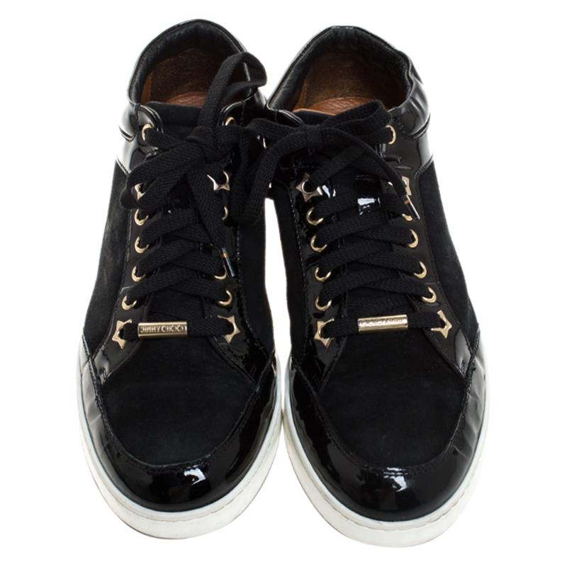 These trendy and chic sneakers from Jimmy Choo will amp up your style. Step out in style and confidence as you wear these attractive low top sneakers crafted from suede and patent leather. They come in black and are styled with lace-ups. They come