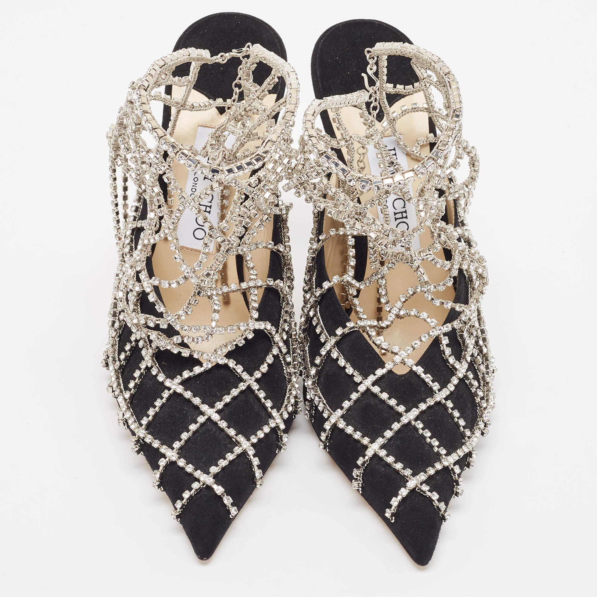 Jimmy Choo yet again brings a stunning pair of pumps that makes us marvel at its beauty and craftsmanship. Crafted from black suede, they are cloaked with a panel of crystal embellishments for the right amount of sheen! Wear these shoes to nail the
