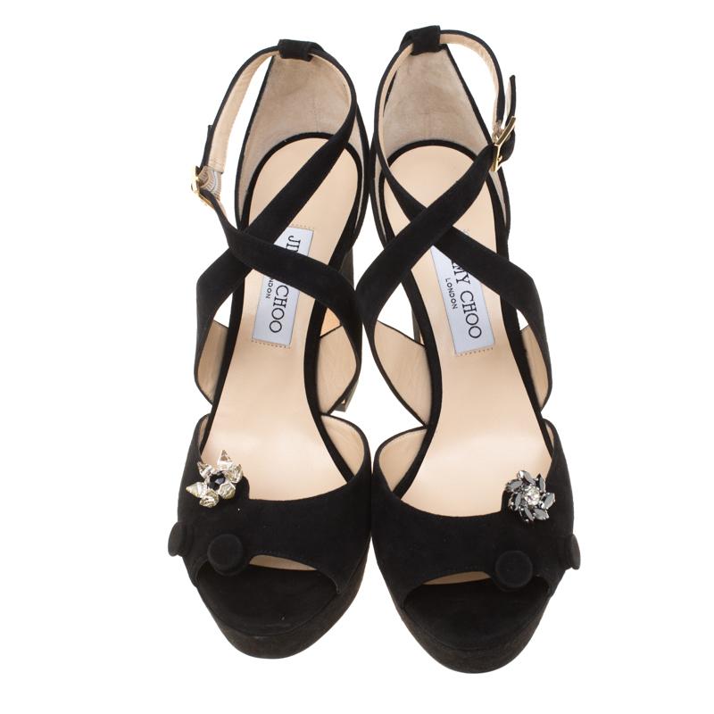 Make a statement like never before and enchant the crowds in these lovely Janet sandals from Jimmy Choo! The black sandals have been crafted from suede and feature an open toe silhouette. They flaunt elegant flower embellishments on the vamps and