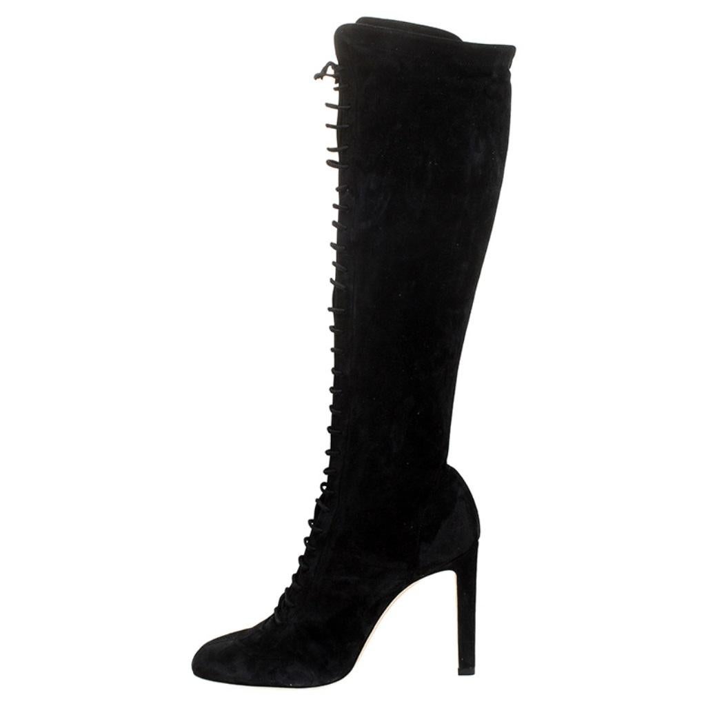 Jimmy Choo has created a unique piece in the form of these lace-up boots. These boots extend up to knee-length and are a deep rich black in color. The soft suede body and high stiletto heels complete the bold look.

Includes: Original Dustbag,