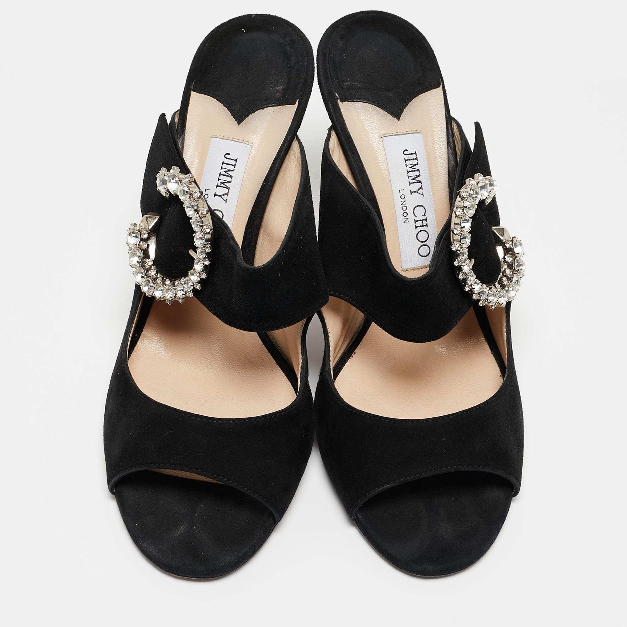 Flaunting a dainty crystal-embellished buckle on the beautiful black suede exterior, these flawless Saf sandals provide your feet with a glamourous style. These slide sandals from Jimmy Choo strike a perfect balance between luxury and simplicity. To