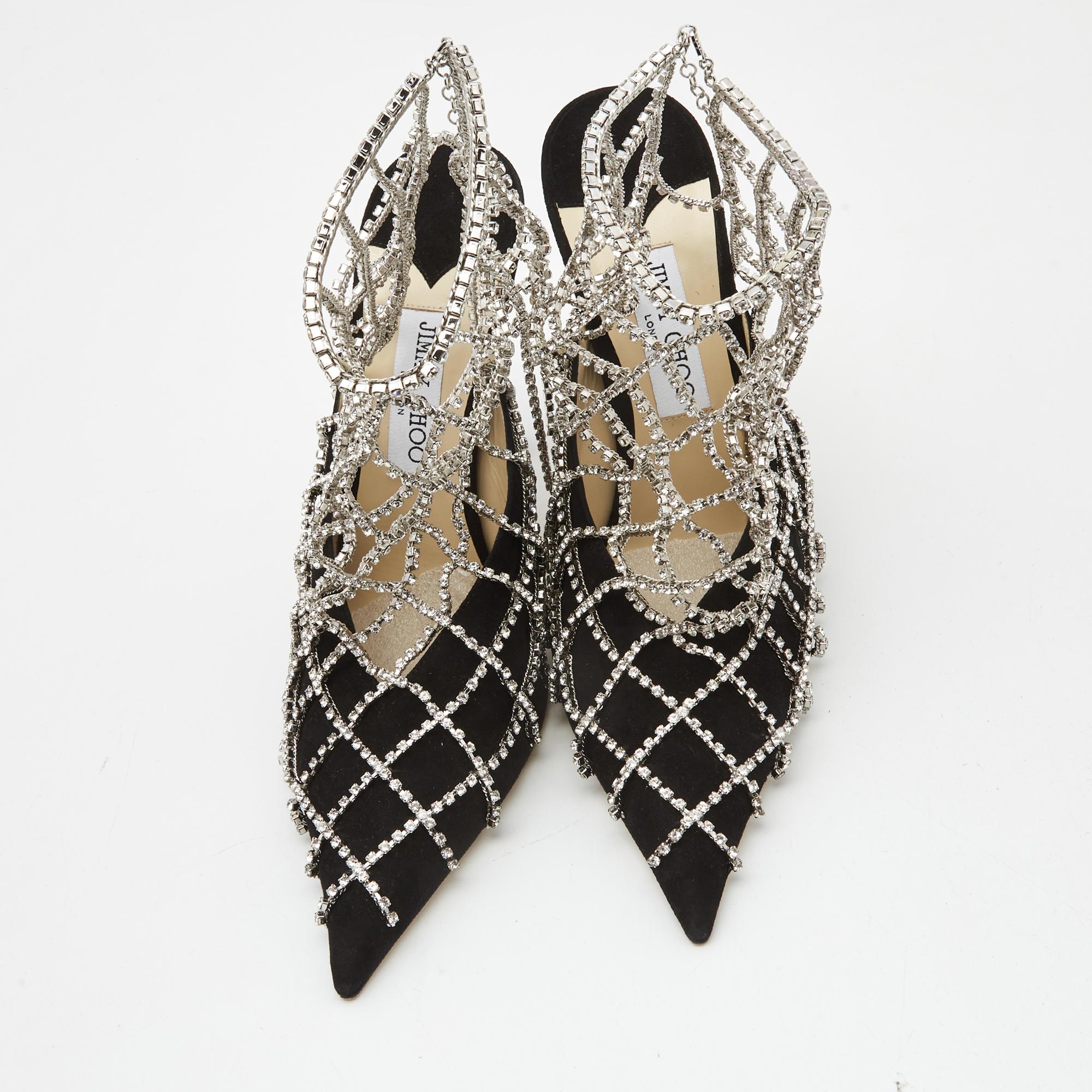Jimmy Choo yet again brings a stunning set of booties that makes us marvel at its beauty and craftsmanship. Crafted from black suede, they are cloaked with a panel of crystal embellishments for the right amount of sheen! Wear these shoes to nail the