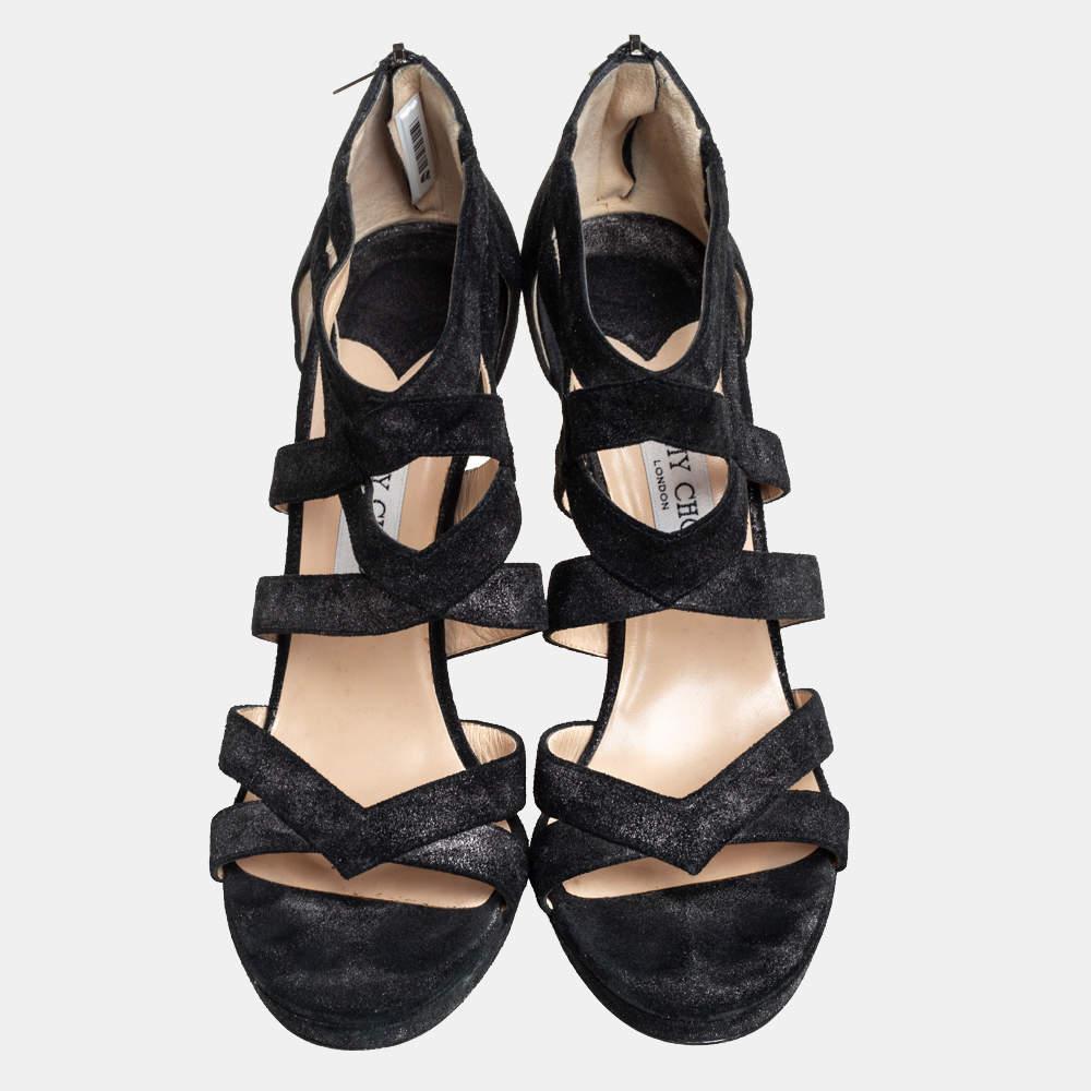 Complete a fashionable look with these stunning sandals from Jimmy Choo. The black sandals are crafted from suede and feature open toes and a strappy silhouette. They come equipped with rear zippers and stand tall on 13 cm stiletto heels. These