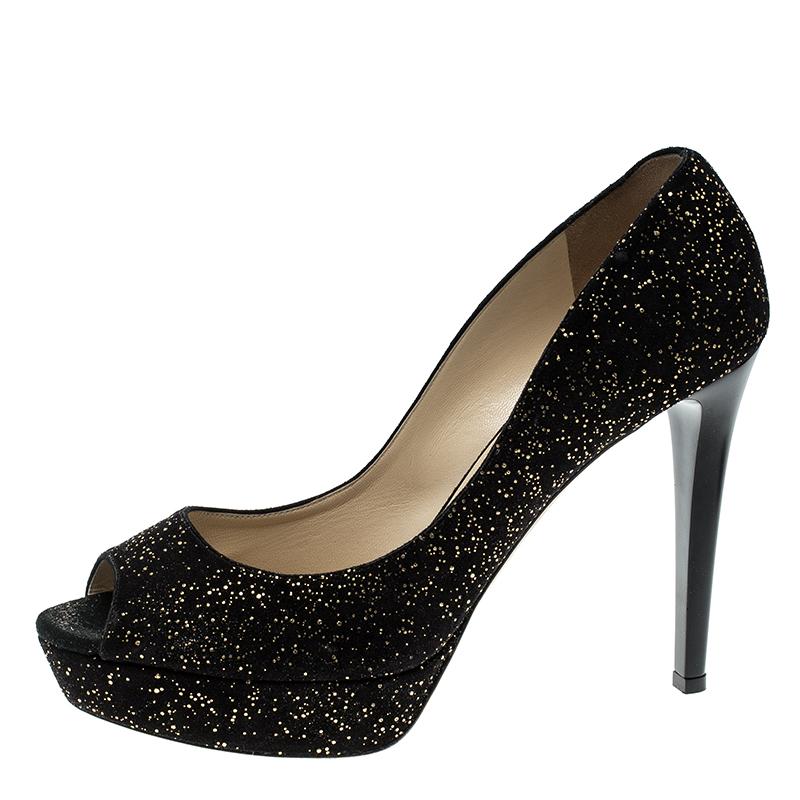 Step out in style and glamour added to your look with these gorgeous pumps from the house of Jimmy Choo. Crafted for comfort in a beautiful textured suede, these peep toe pumps stand apart on platforms and high heels. The gold adds the bling to your