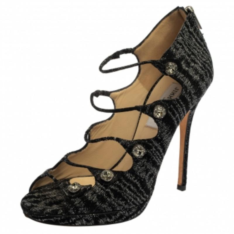 Simply stylish, these sandals from the house of Jimmy Choo are a classic pair to own. Crafted with black tweed, they have a strappy upper body embellished with crystals that lend the pair a glamorous look. Complete with 13 cm heels, these sandals