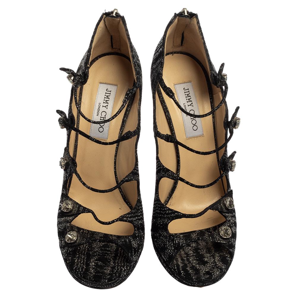 Simply stylish, these sandals from the house of Jimmy Choo are a classic pair to own. Crafted with black tweed, they have a strappy upper body embellished with crystals that lend the pair a glamorous look. Complete with 13 cm heels, these sandals