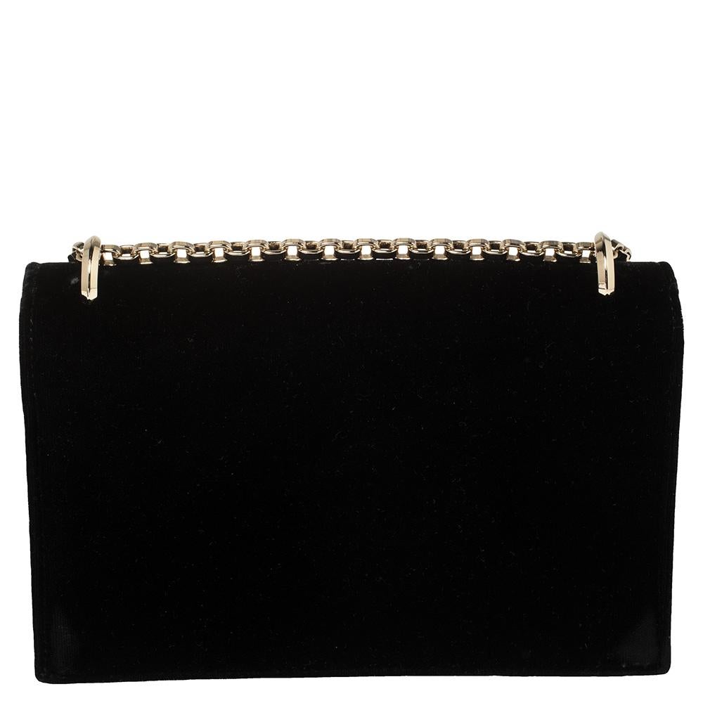 Bringing elegance and class to your wardrobe, this wallet on chain from Jimmy Choo is stylish and convenient! It has been crafted from black velvet and styled with a front flap that has the signature 'JC' logo detailing and opens to a fabric-lined