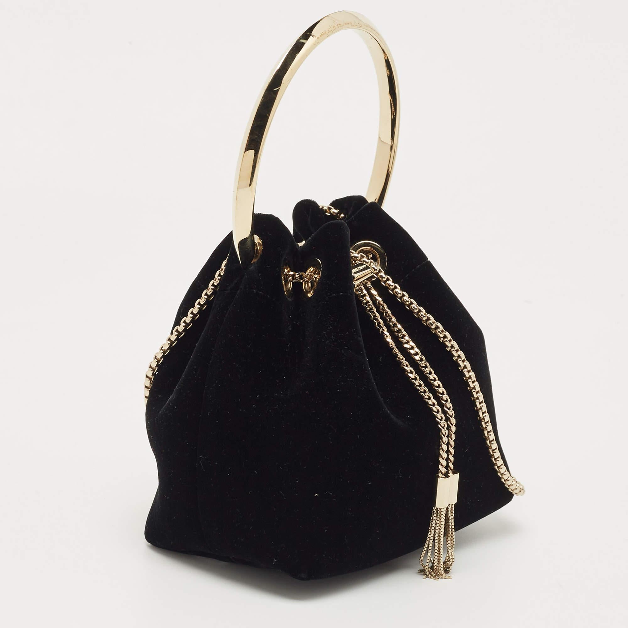 Jimmy Choo's BonBon has a classy silhouette and a glamorous appeal. Constructed using velvet, the bag has a drawstring closure. The gold-tone metal handle and chain act as the design's highlight.

