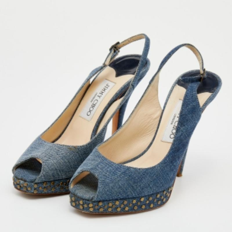 This timeless pair of platform sandals from Jimmy Choo looks even better on the feet. The shoes have an elegant design made from blue denim, complemented by high heels, studded platforms, and buckle slingbacks for a sleek finish.