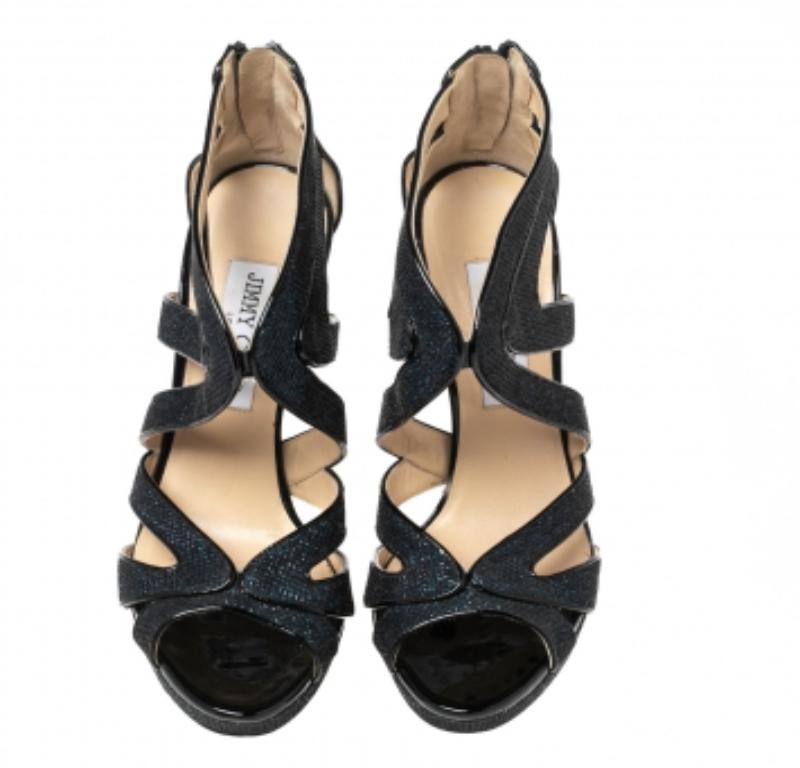 Durable and eye-catching, these Jimmy Choo Leila sandals will update your footwear collection. Constructed from glitter, lamé fabric, and patent leather, the design has been beautified with attractive cutouts and secured with branded zipper closure.