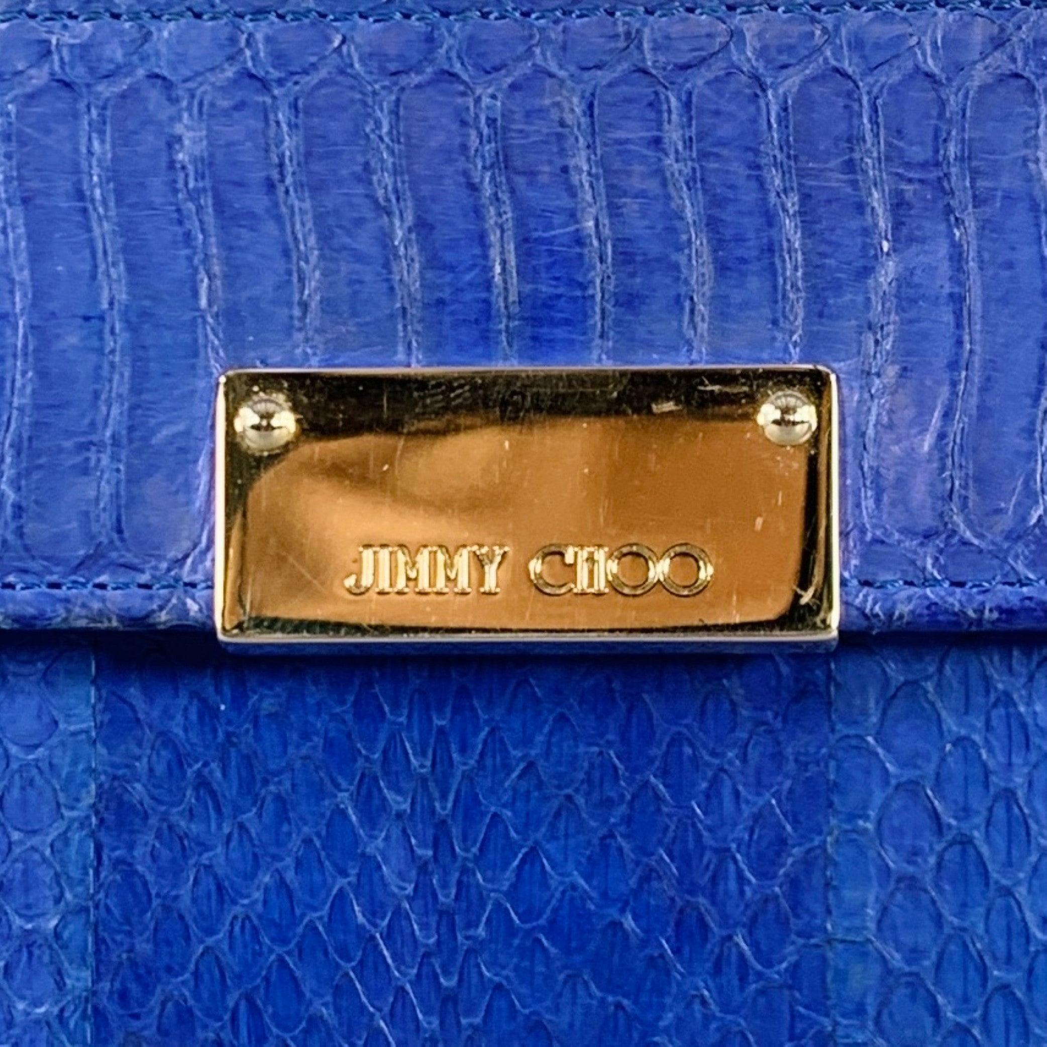 JIMMY CHOO handbag
in a blue snakeskin leather featuring a clutch style, silver tone metal hardware, and snap closure. Made in Italy.Very Good Pre-Owned Condition. Moderate marks inside, please check photos. As is. 

Measurements: 
  Length: 9.5