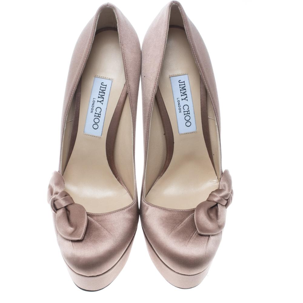 Scintillating, regal and standing tall like no other, these blush pink pumps from Jimmy Choo will enchant one and all! The Kenedy pumps are crafted from satin and feature round toes with a lovely bow detailing on the sides, comfortable leather lined