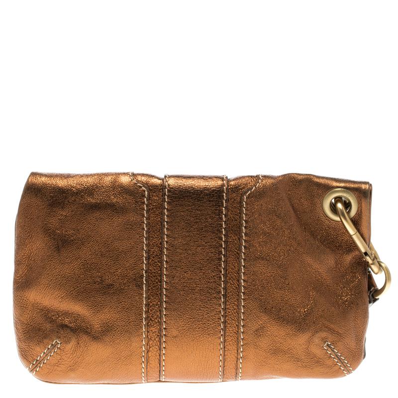 This stylish Mave Foldover clutch from Jimmy Choo is crafted from leather. The lovely clutch comes with a wristlet and a front zip detailing. The insides are suede lined and will keep your essentials close at hand.

Includes: Original Dustbag