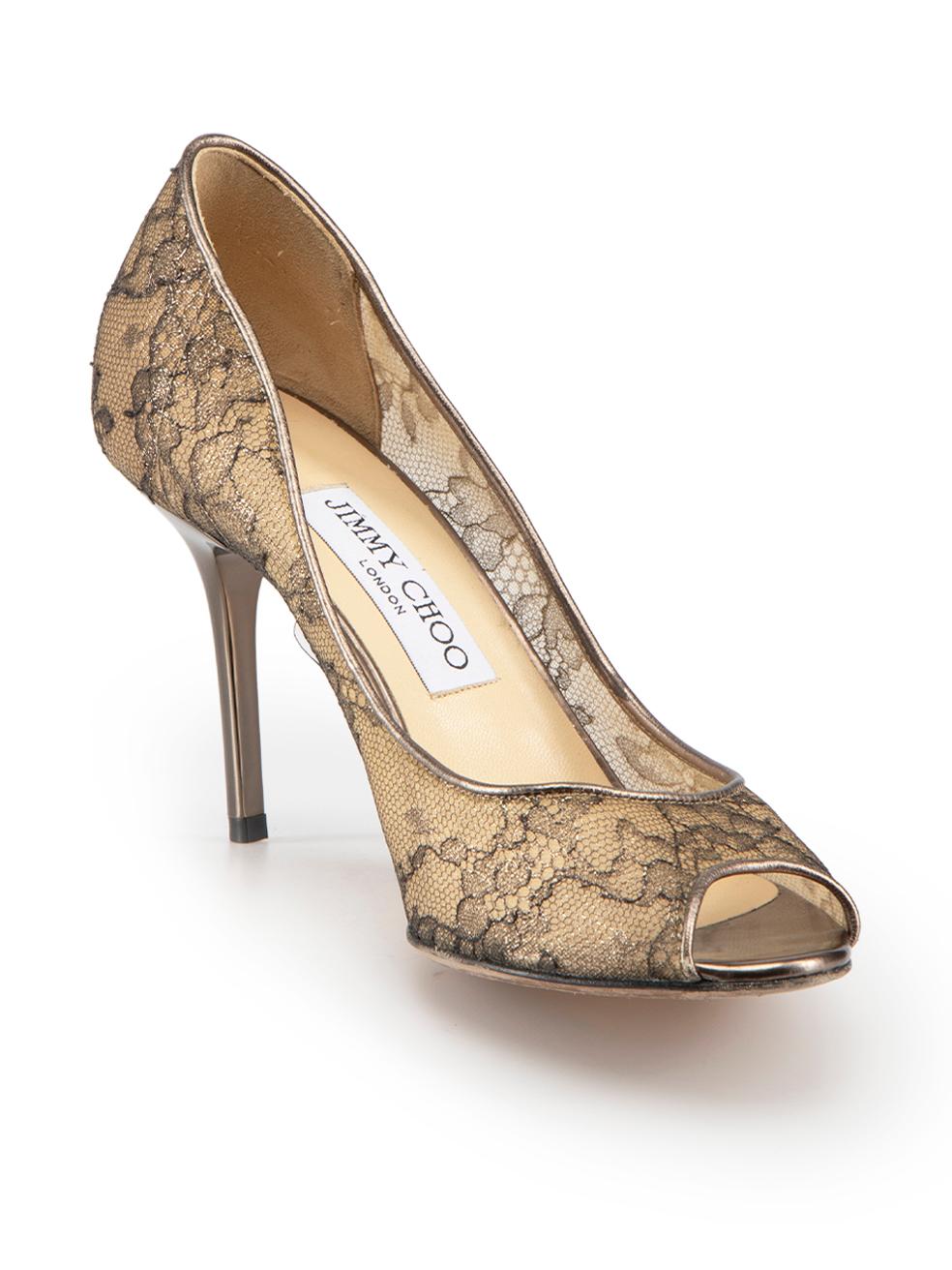 CONDITION is Very good. Minimal wear to heels is evident. Minimal wear to the heels of both shoes with very light scratches on this used Jimmy Choo designer resale item.
 
Details
Bronze
Lace
Slip on heels
Sheer floral lace accent
Peep toe
High