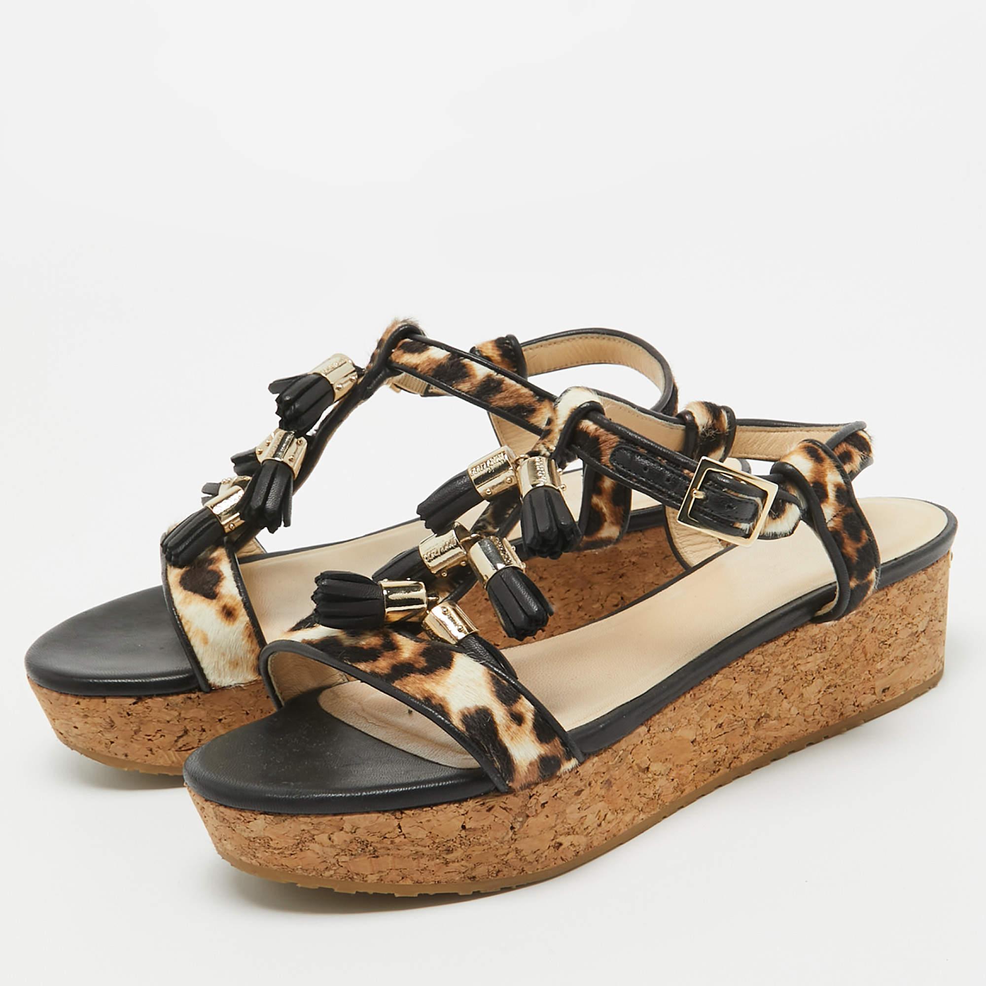 Lend an elegant finish to your look of the day with these Jimmy Choo wedge sandals. Little tassel detailing on the uppers heightens the pairs appeal.