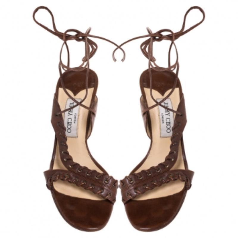 These fashionable sandals from Jimmy Choo can give your entire ensemble a makeover. These brown sandals have been crafted from quality leather in Italy. They are styled with open toes, corset-style vamps with ankle wraps, 10 cm heels and bronze-tone