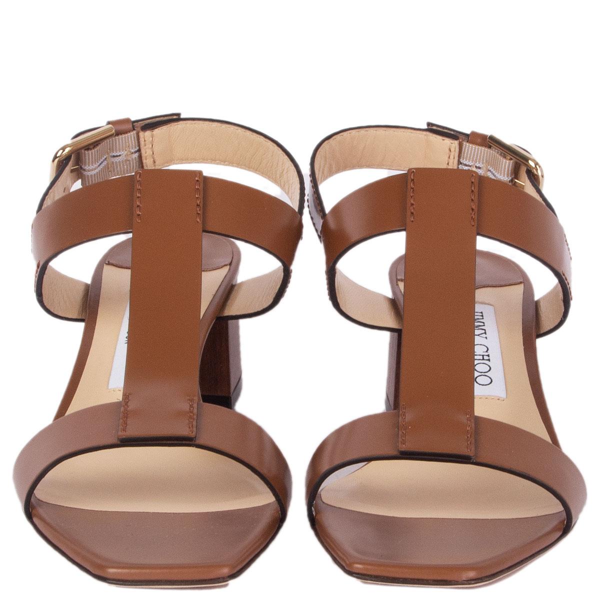 100% authentic Jimmy Choo 'Jin' slingback sandals in brown calfskin with brown wooden block-heel. Brand new. Come with dust bag. 

Imprinted Size	37.5
Shoe Size	37.5
Inside Sole	24cm (9.4in)
Width	7.5cm (2.9in)
Heel	5cm (2in)
Hardware	Light