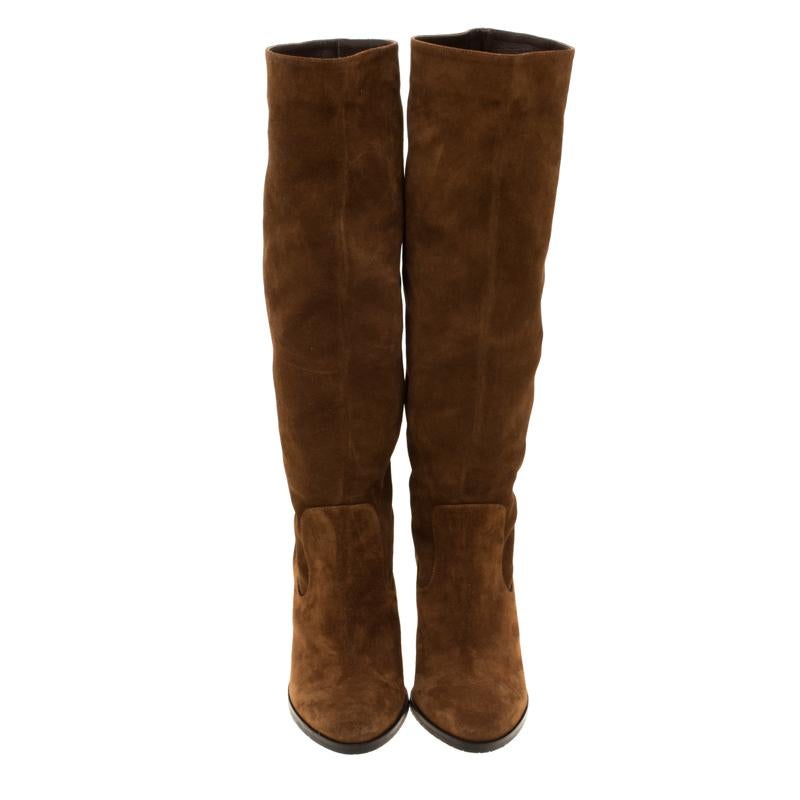 Simple and sophisticated, these knee length boots from Jimmy Choo are a must-buy for the fashionable you. These brown boots are crafted in suede and come balanced on 10 cm heels. They can be paired with a long tunic or an oversized shirt to make