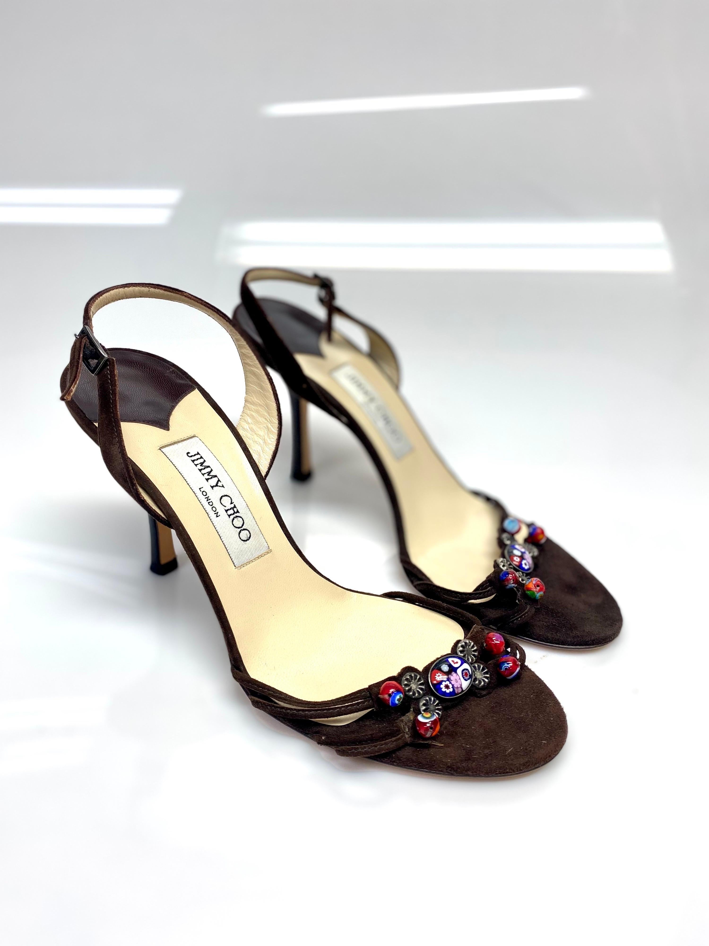 Jimmy Choo Brown Suede Slingback Sandal with Beaded Detailing Size 39. These Jimmy Choo suede slingback sandals celebrate the brand's expert attention to detail. The shoe features chocolate brown suede and beads adorning the front of the shoe. Item