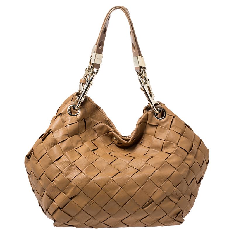 A bag for all reasons and seasons, this Jimmy Choo hobo has a beautiful woven leather exterior rendered in a stylish shape and a suede interior to house your belongings. The hobo is easy to hold and flaunt.

Includes: The Luxury Closet Packaging

