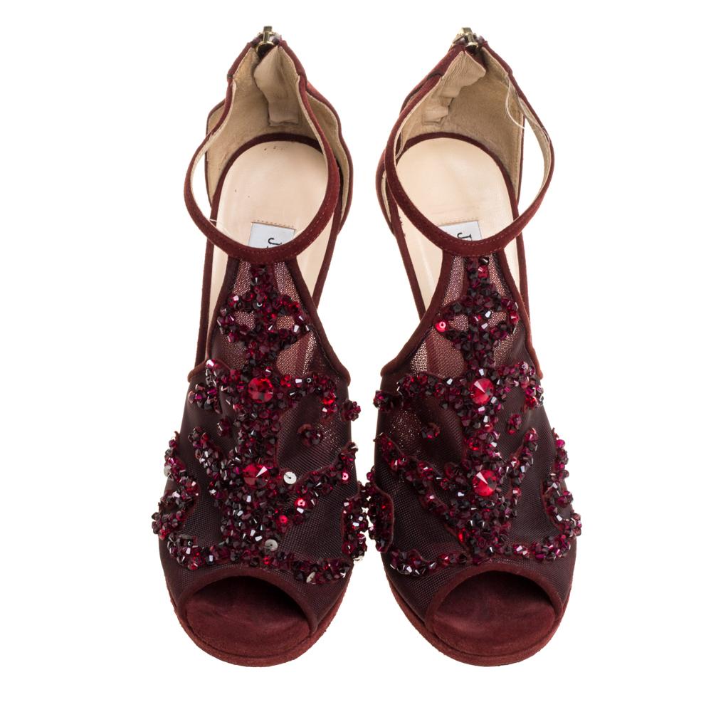 Dazzle the crowds and make a statement like never before in these gorgeous sandals from Jimmy Choo! These burgundy sandals have been crafted from mesh and suede into a peep-toe silhouette and adorned with beautiful crystal embellishments on the