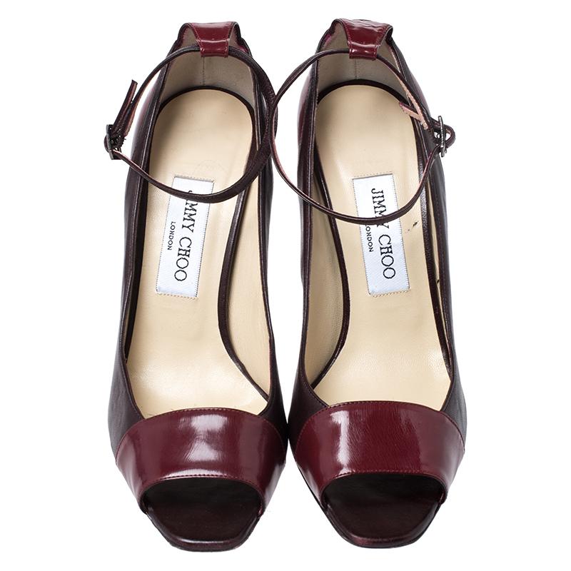 Elevate your look by flaunting these pumps crafted from premium quality leather and patent leather. This Jimmy Choo pair is styled with peep toes, towering stiletto heels and ankle fastenings. Add a touch of sophistication to your ensemble by